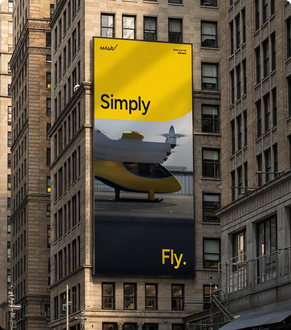Vertical Wisk billboard on a city building: Simply Fly., with the yellow aircraft